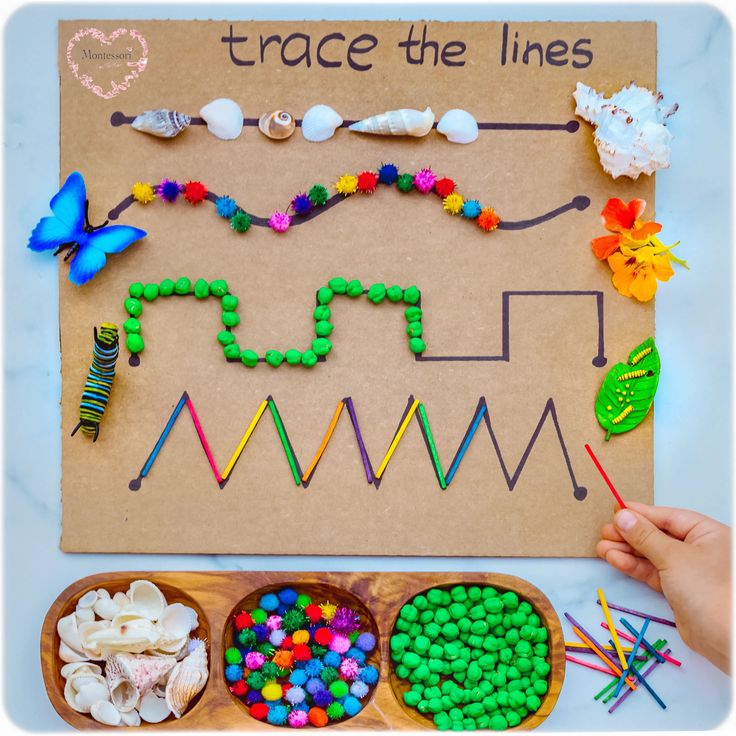 Children’s tracing board with shells, pom-poms, and beads on lines