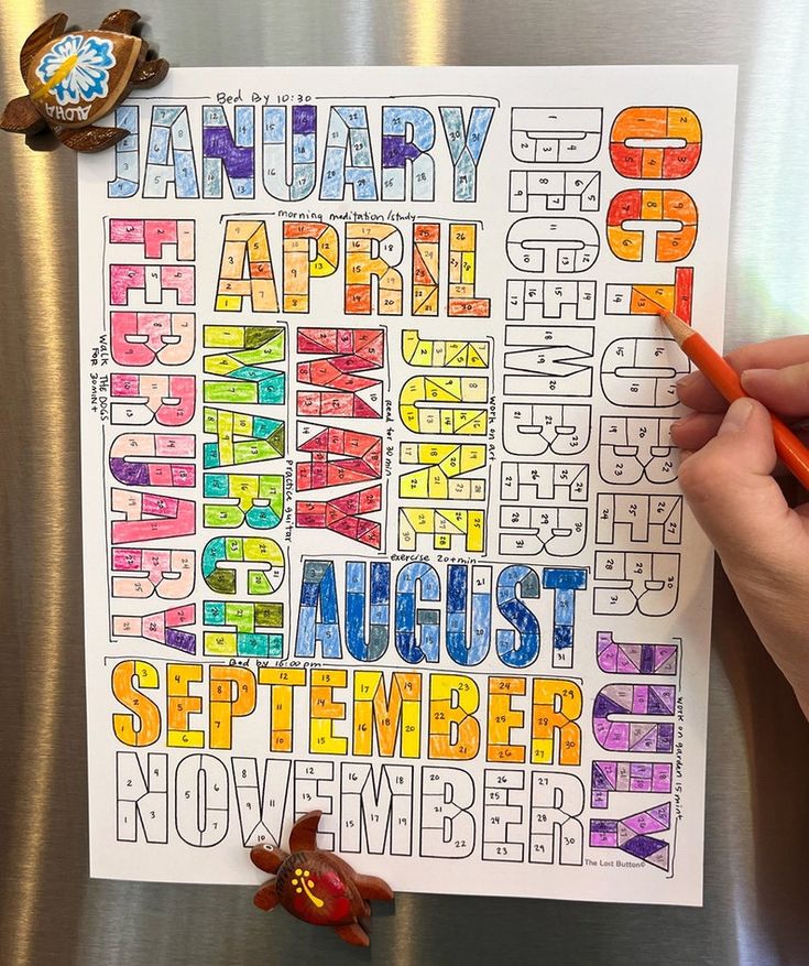 Colorful hand-colored year calendar on white paper, with turtle magnets