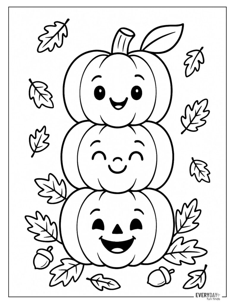 Three smiling stacked pumpkins with scattered leaves and acorns