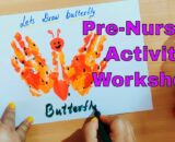 Child painting butterfly on worksheet with paint bottles and pen